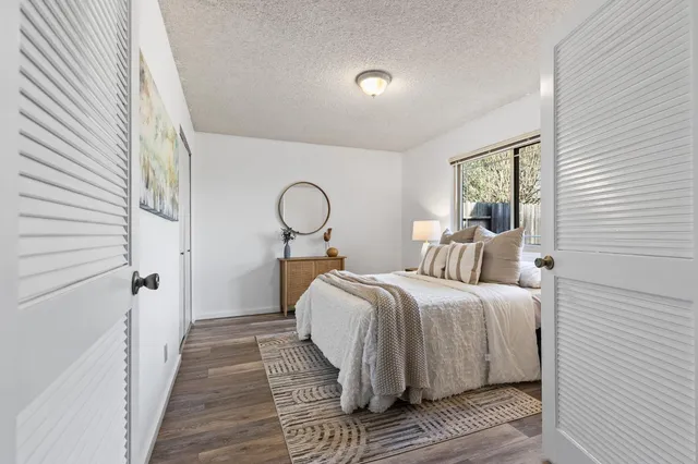 a bedroom with a large bed and a window