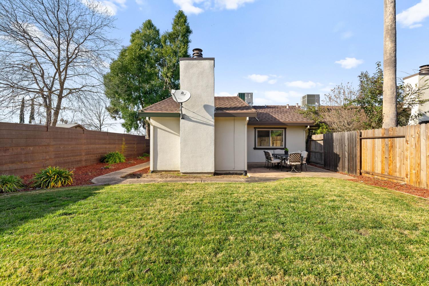 10938 Anza Way Rancho Cordova, CA 95670 - Photo 28 of 37 a view of a house with a backyard and a tree