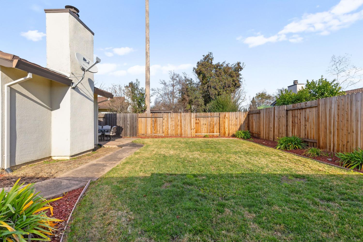 10938 Anza Way Rancho Cordova, CA 95670 - Photo 30 of 37 a view of a backyard with wooden fence