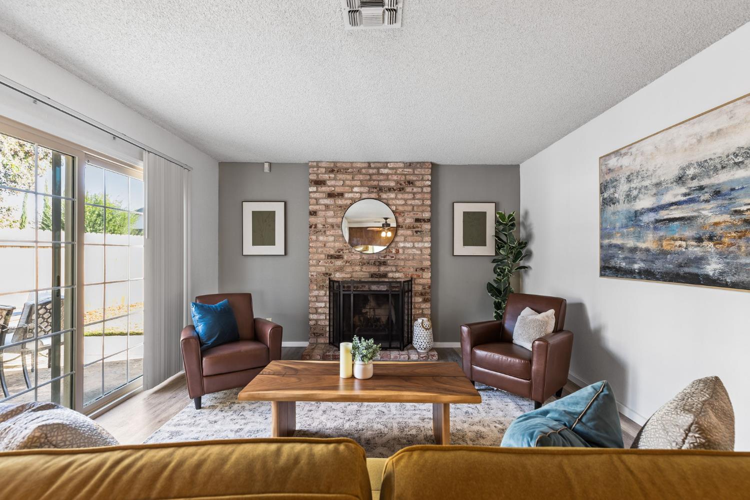 10938 Anza Way Rancho Cordova, CA 95670 - Photo 4 of 37 a living room with furniture a fireplace and a large window