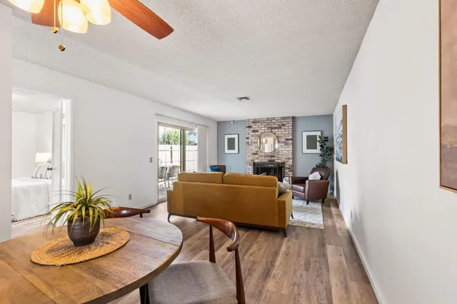 a living room with furniture and wooden floor