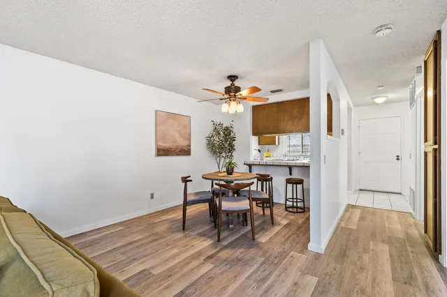 a view of a dining room with furniture and wooden floor