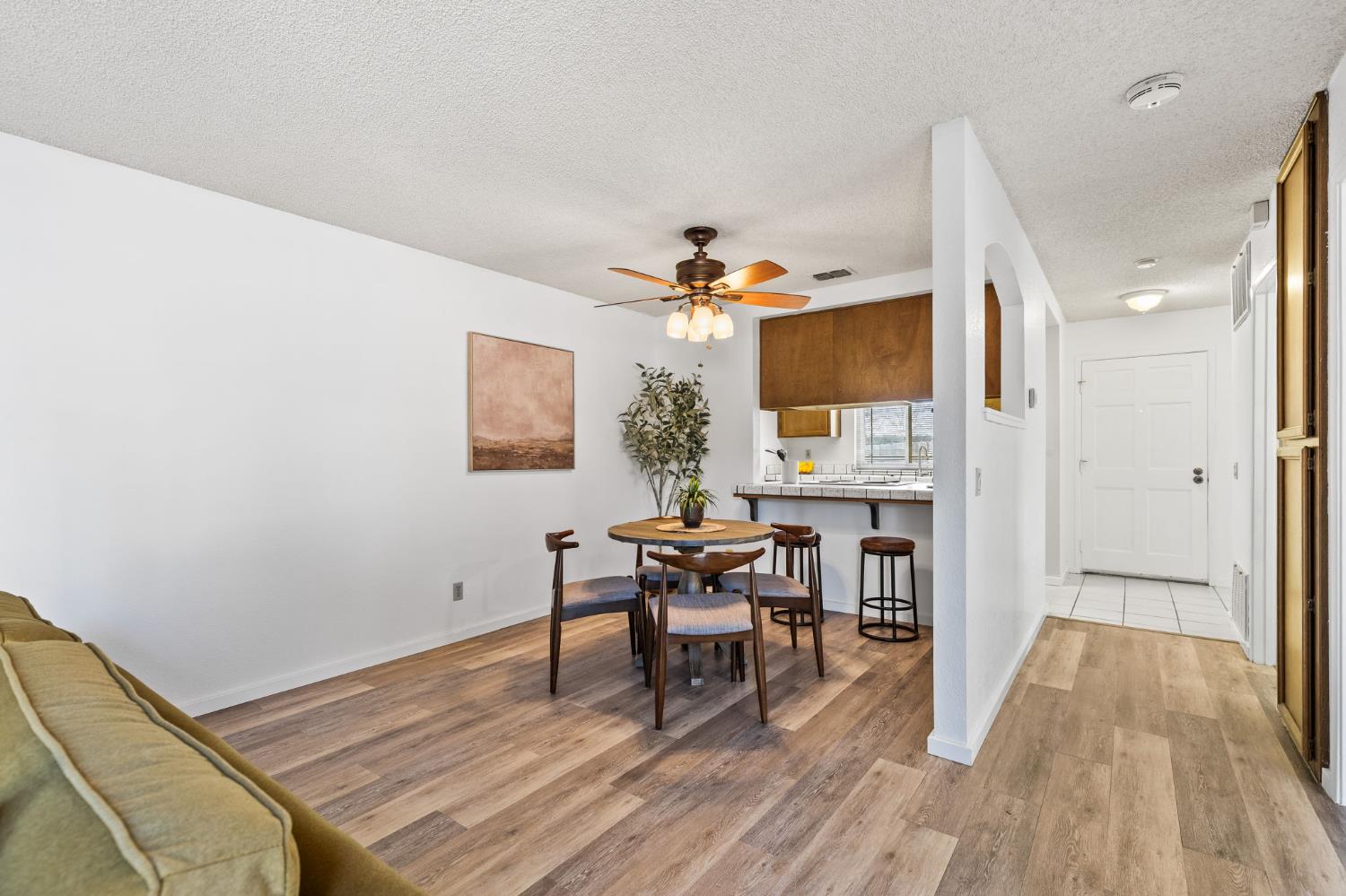 10938 Anza Way Rancho Cordova, CA 95670 - Photo 6 of 37 a view of a dining room with furniture and wooden floor
