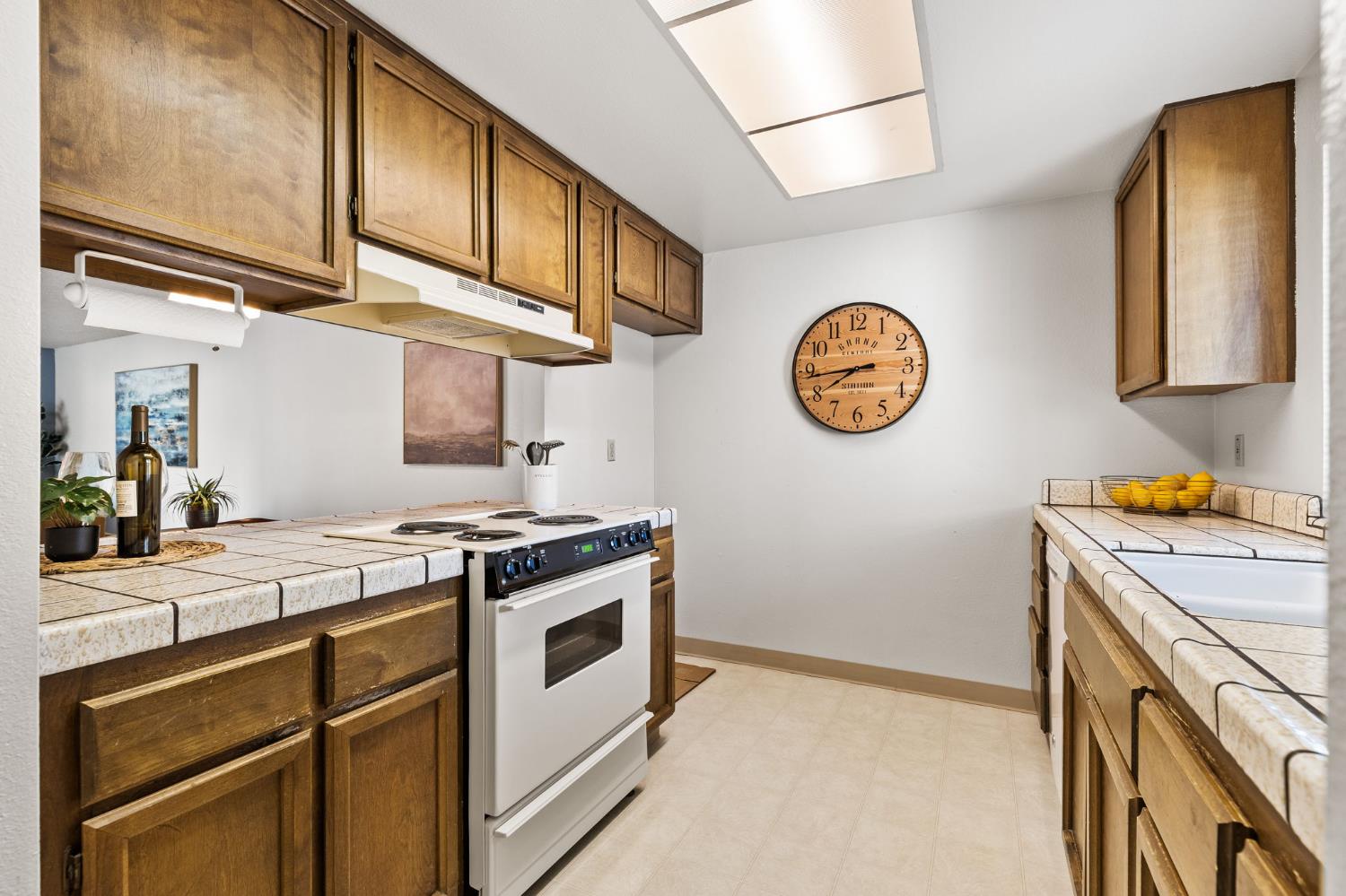 10938 Anza Way Rancho Cordova, CA 95670 - Photo 10 of 37 a kitchen with a stove and a clock