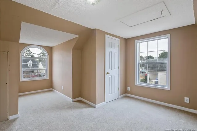 a view of an empty room and closet area
