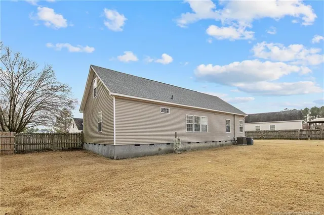 a view of a house with a yard and lake view
