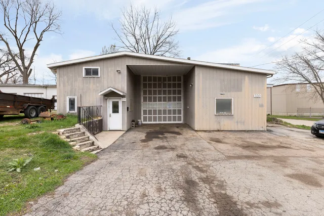 a view of a house with a yard and garage