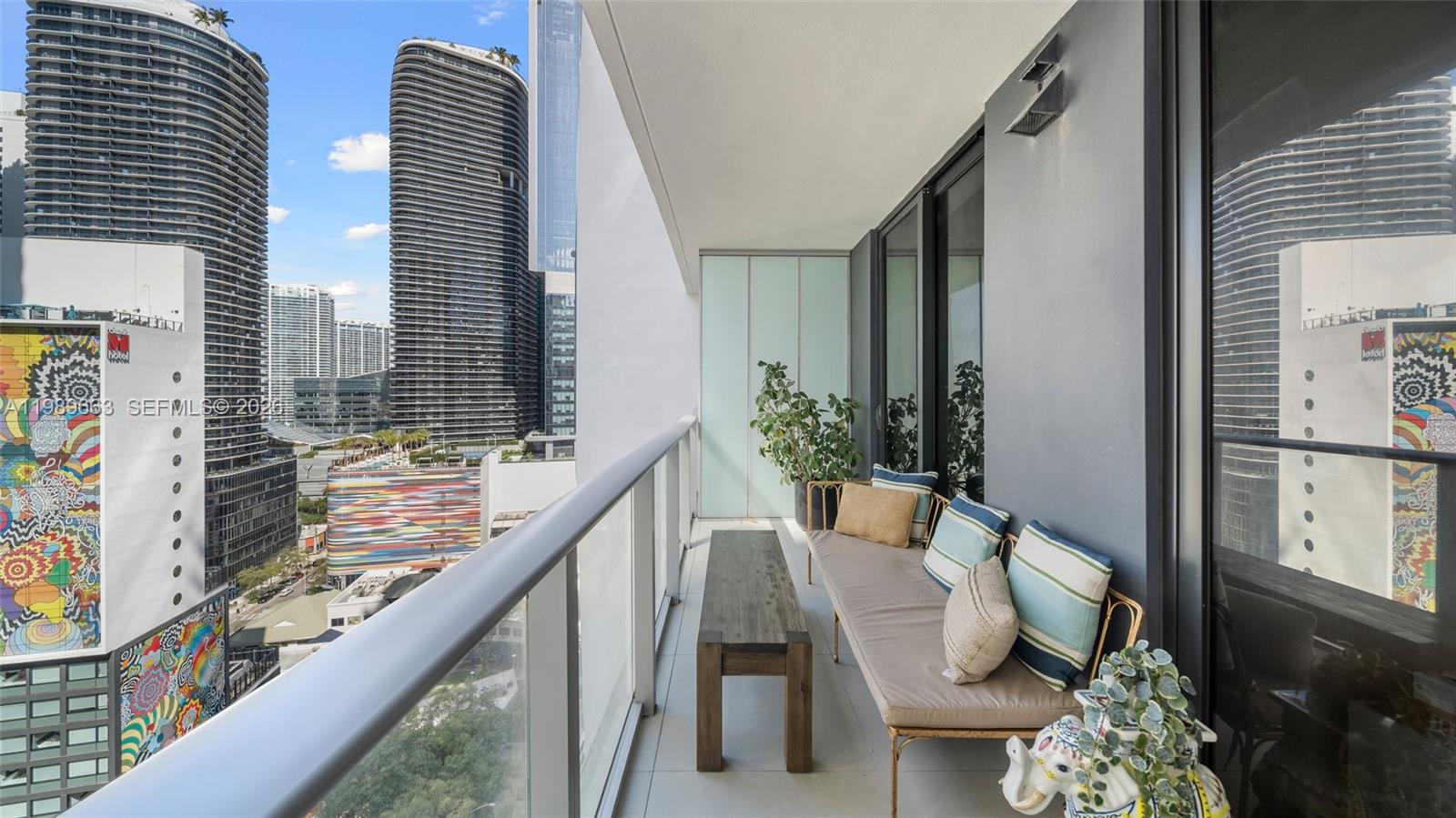 1010 Brickell Avenue, Unit 2008 Miami, FL 33131 - Photo 1 of 26 a balcony with chairs and with potted plants