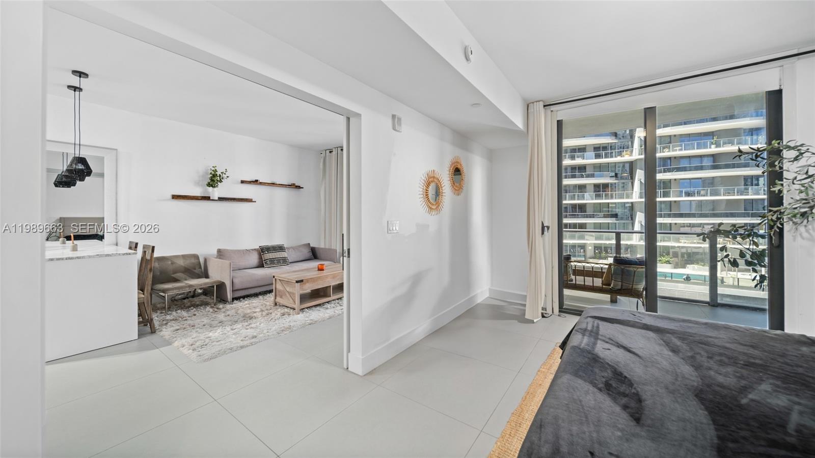 1010 Brickell Avenue, Unit 2008 Miami, FL 33131 - Photo 11 of 26 a living room with furniture a large window and walk in closet