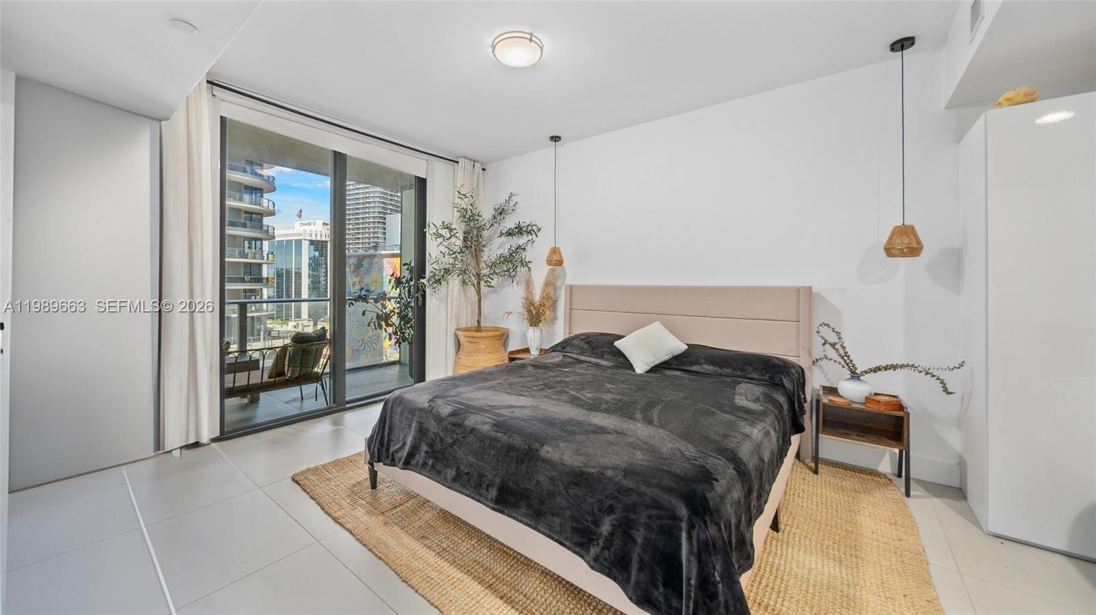 1010 Brickell Avenue, Unit 2008 Miami, FL 33131 - Photo 13 of 26 a bedroom with a bed and a mirror