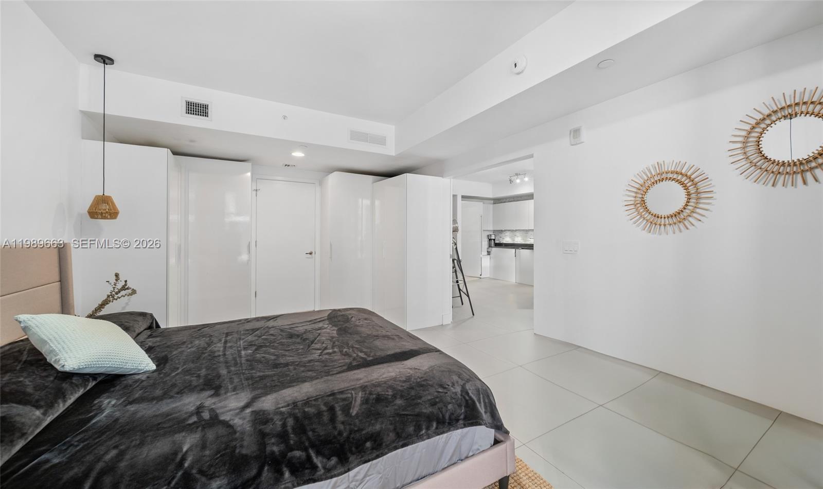 1010 Brickell Avenue, Unit 2008 Miami, FL 33131 - Photo 14 of 26 a bedroom with a bed and cabinets