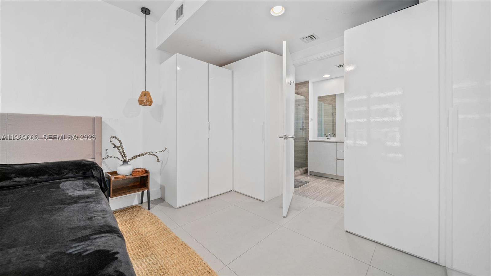 1010 Brickell Avenue, Unit 2008 Miami, FL 33131 - Photo 15 of 26 a hallway with a couch and a stove top oven