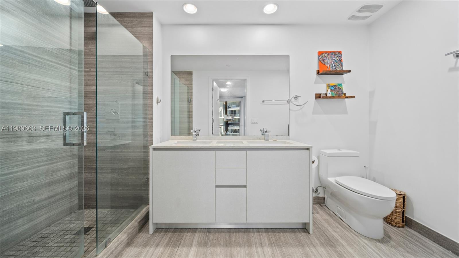 1010 Brickell Avenue, Unit 2008 Miami, FL 33131 - Photo 16 of 26 a bathroom with a sink a toilet and shower