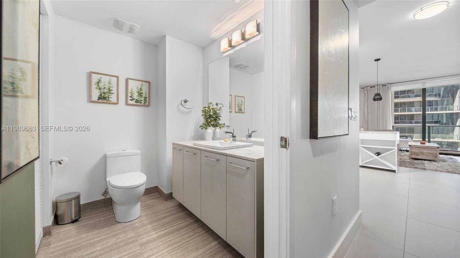 1010 Brickell Avenue, Unit 2008 Miami, FL 33131 - Photo 2 of 26 a bathroom with a toilet sink and mirror