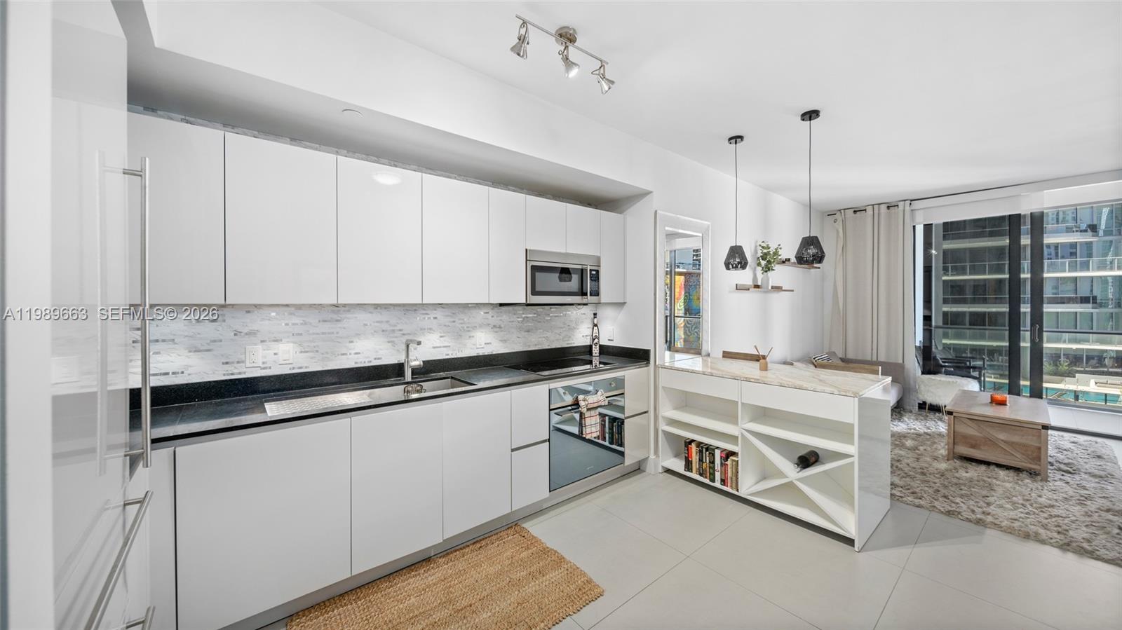 1010 Brickell Avenue, Unit 2008 Miami, FL 33131 - Photo 5 of 26 a kitchen with stainless steel appliances granite countertop a stove and a sink