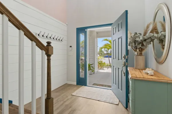 a view of an entryway with wooden floor