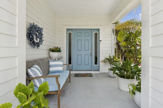 a front view of a building with glass door and deck