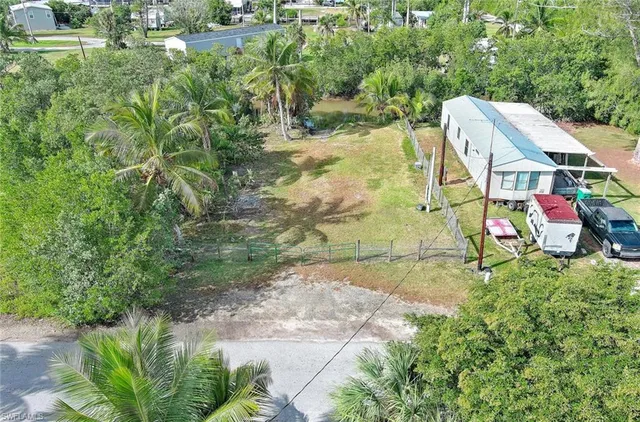 a aerial view of a house with a yard basket ball court and outdoor seating