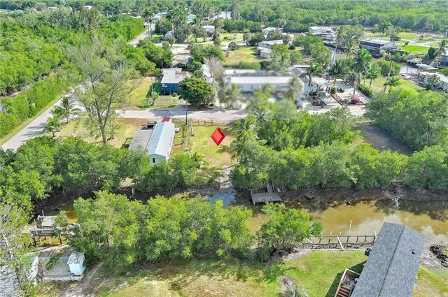 an aerial view of residential houses with outdoor space and swimming pool