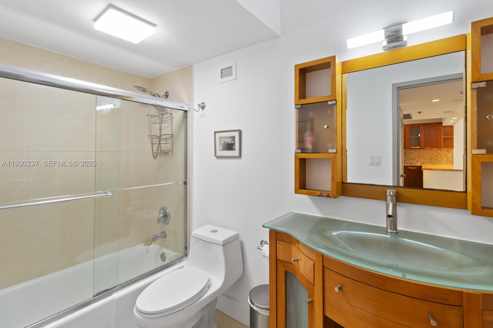 100 Lincoln Road, Unit 543 Miami Beach, FL 33139 - Photo 14 of 17 a bathroom with a granite countertop sink toilet and shower