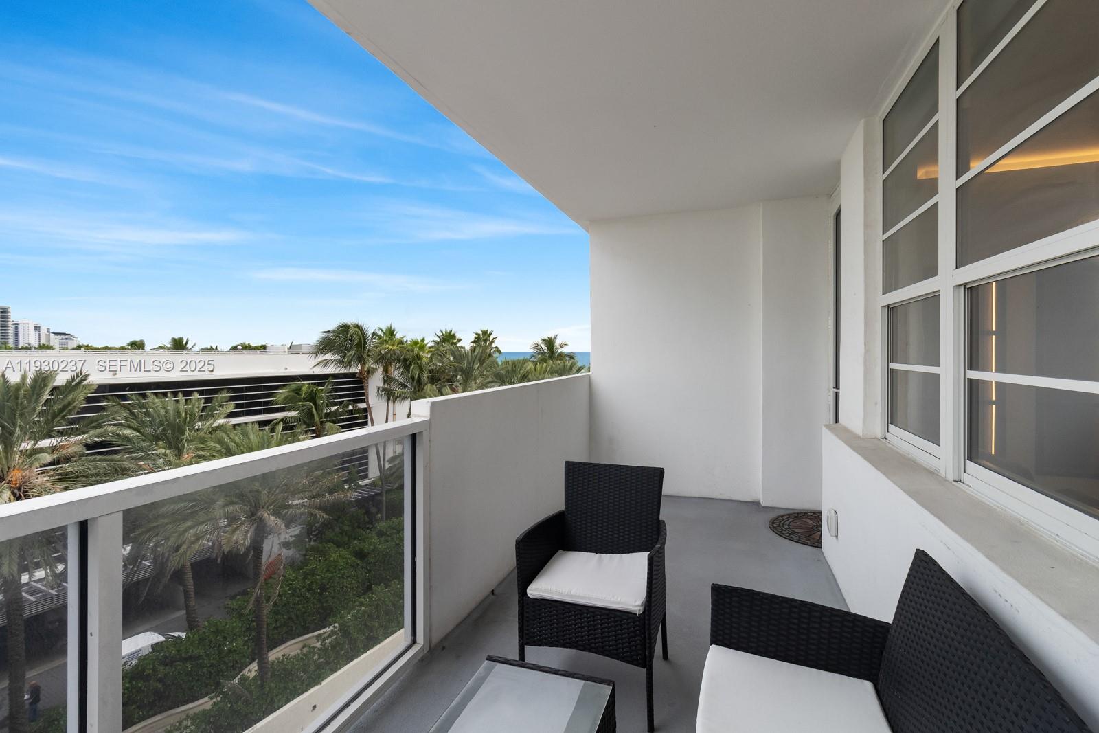 100 Lincoln Road, Unit 543 Miami Beach, FL 33139 - Photo 3 of 17 a view of a balcony with chair and wooden floor