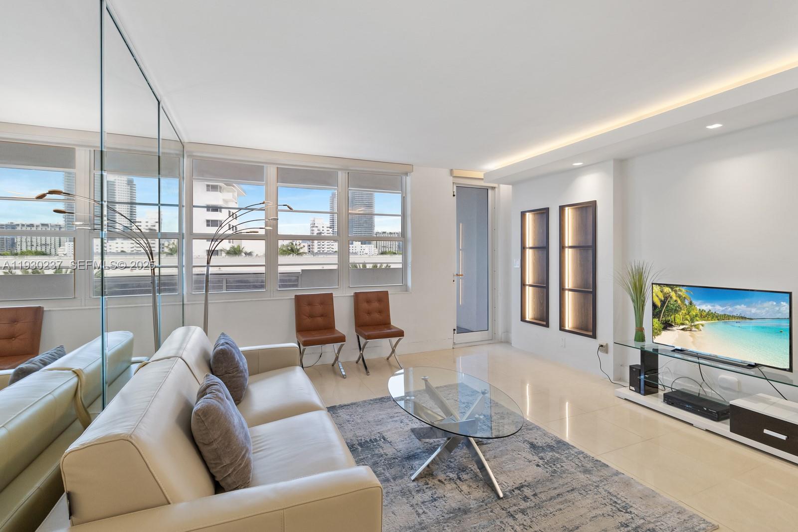 100 Lincoln Road, Unit 543 Miami Beach, FL 33139 - Photo 10 of 17 a living room with furniture and a flat screen tv