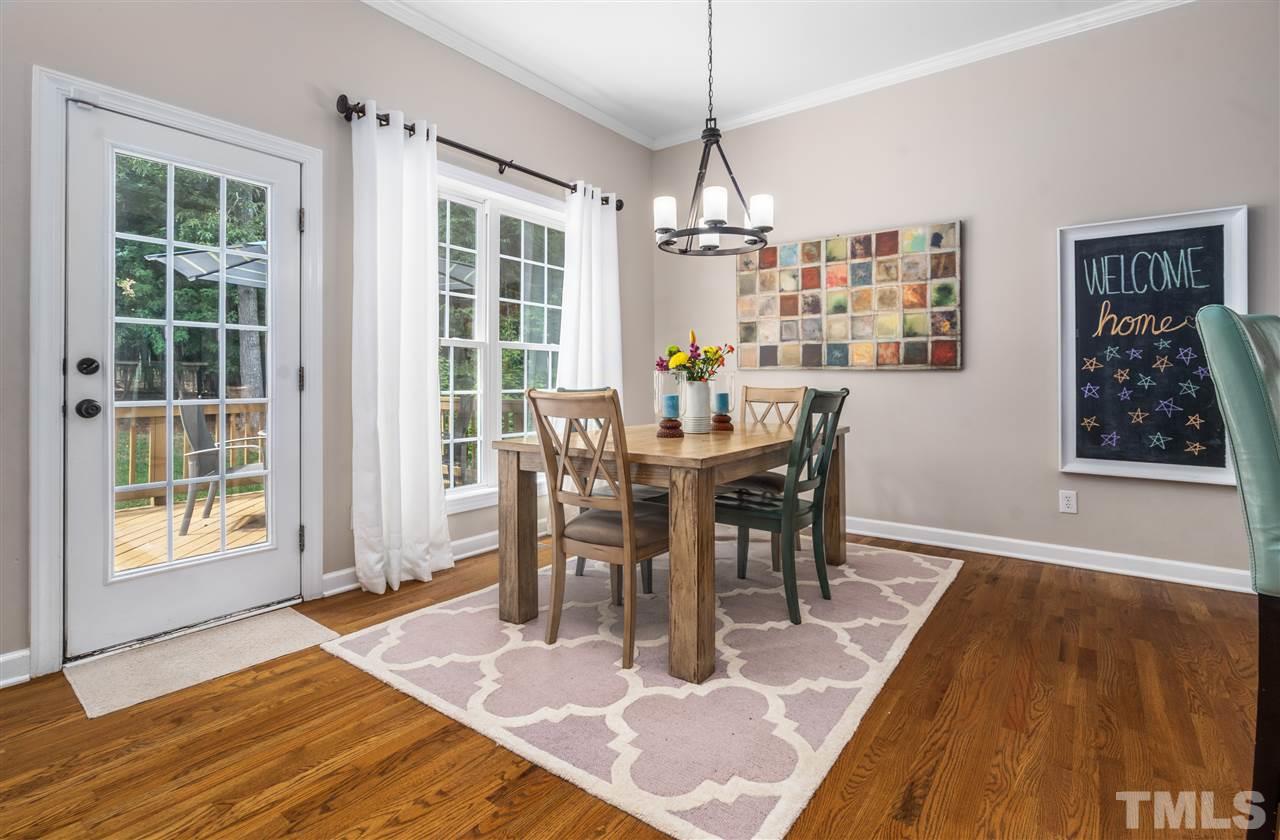 1520 Wood Spring Court Raleigh, NC 27614 - Photo 14 of 30 a view of a dining room with furniture window and wooden floor