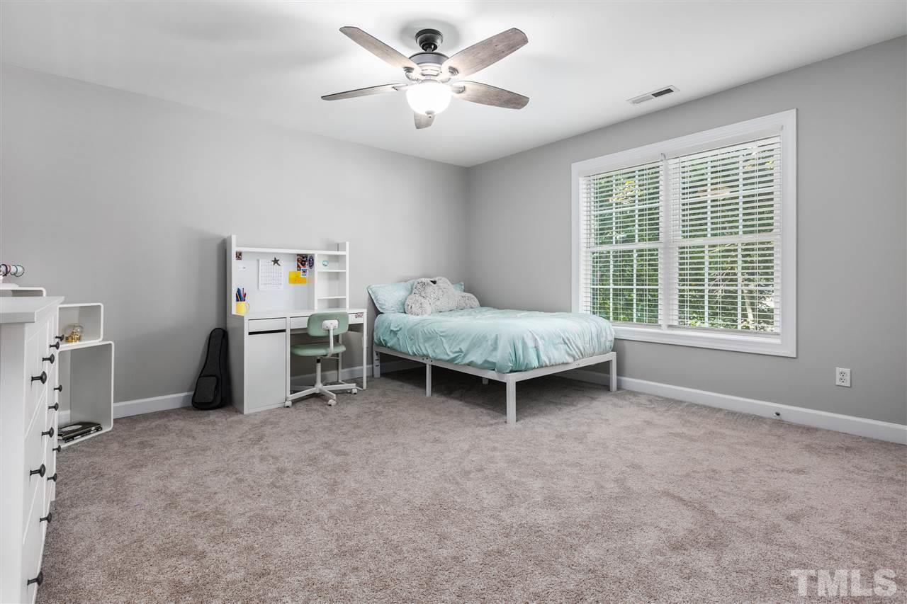 1520 Wood Spring Court Raleigh, NC 27614 - Photo 22 of 30 a spacious bedroom with a bed and a ceiling fan