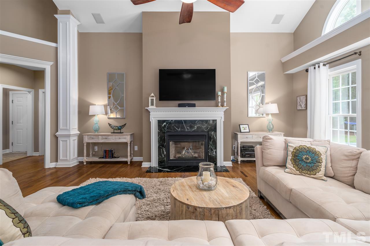 1520 Wood Spring Court Raleigh, NC 27614 - Photo 5 of 30 a living room with furniture flat screen tv and a fireplace