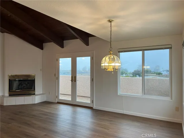 a view of a hallway with wooden floor and a fireplace