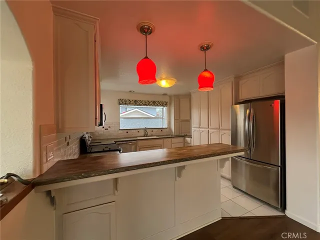 a kitchen with granite countertop stainless steel appliances a stove sink and microwave