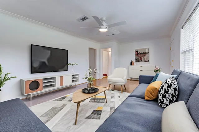 a living room with furniture and a flat screen tv