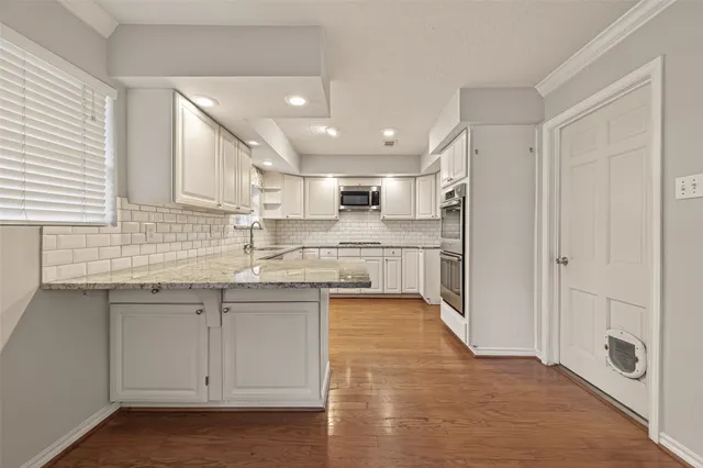 an empty room with a bathroom and a ceiling fan