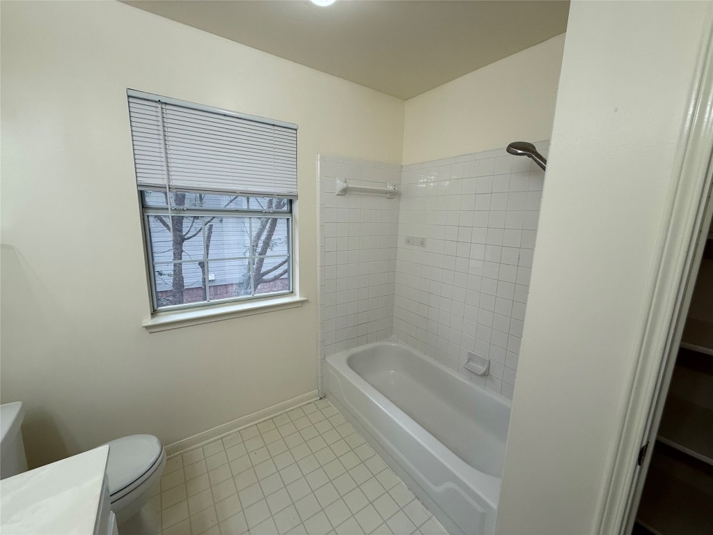 2438 Falcon Drive Round Rock, TX 78681 - Photo 11 of 18 a bath room with a toilet and a bath tub
