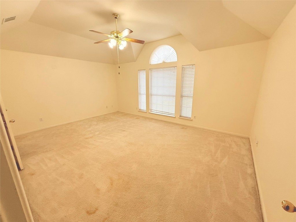 2438 Falcon Drive Round Rock, TX 78681 - Photo 13 of 18 an empty room with a chandelier fan and window