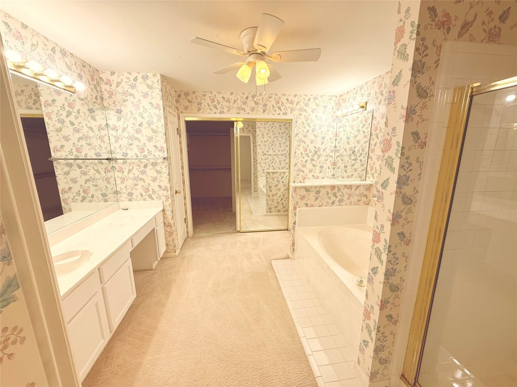2438 Falcon Drive Round Rock, TX 78681 - Photo 15 of 18 a bathroom with a tub sink and shower