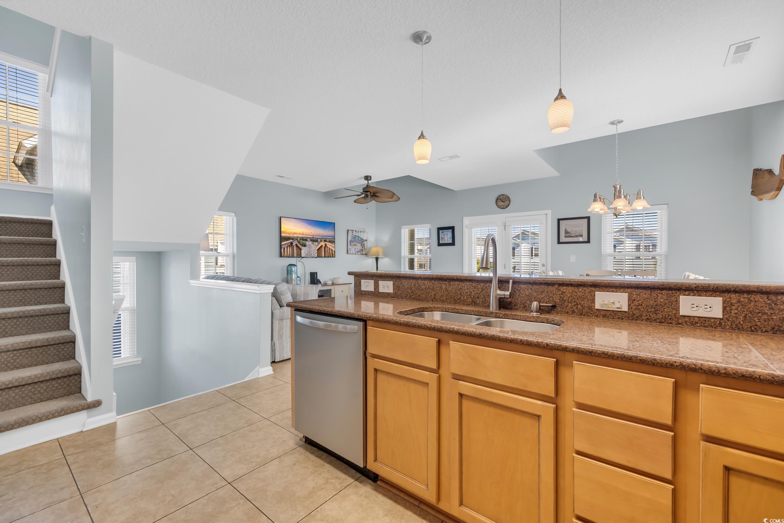 512 North Ocean Boulevard Surfside Beach, SC 29575 - Photo 31 of 39 Kitchen with light tile patterned floors, hanging light fixtures, a sink, dishwasher, and ceiling fan with notable chandelier