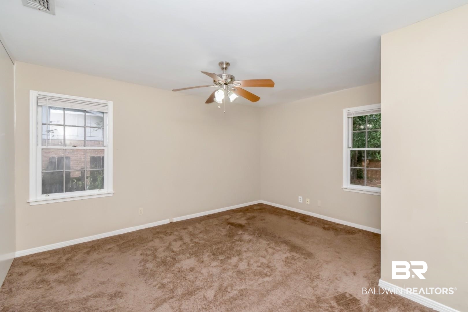 324 Judson Drive Mobile, AL 36608 - Photo 9 of 20 Unfurnished room with healthy amount of natural light, ceiling fan, and carpet