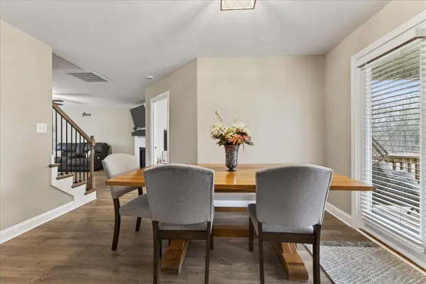 a view of a dining room with furniture and wooden floor