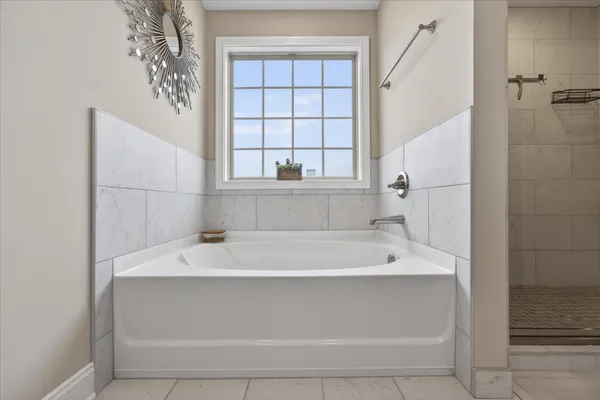 a bathroom with a bathtub and shower