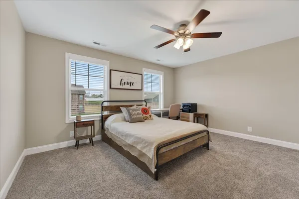 a bedroom with a bed and window