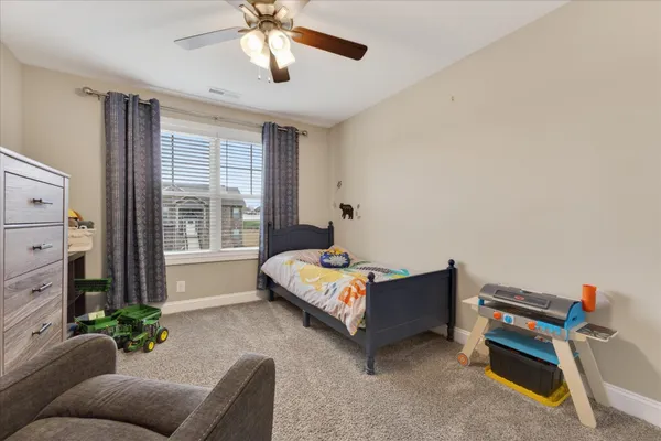 a bedroom with a bed and a chandelier