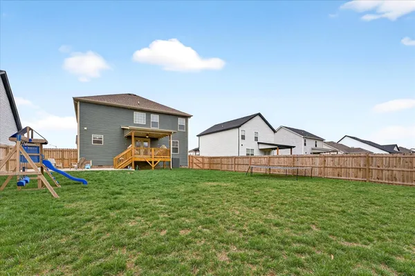 a view of a house with a yard and porch