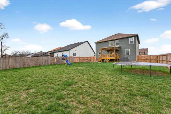 a view of a house with backyard and porch