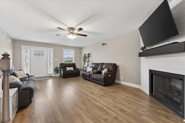 a living room with furniture and a fireplace