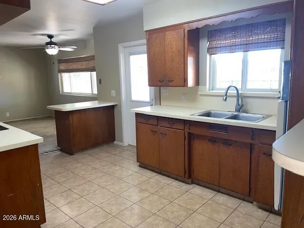 a kitchen with a sink cabinets and window