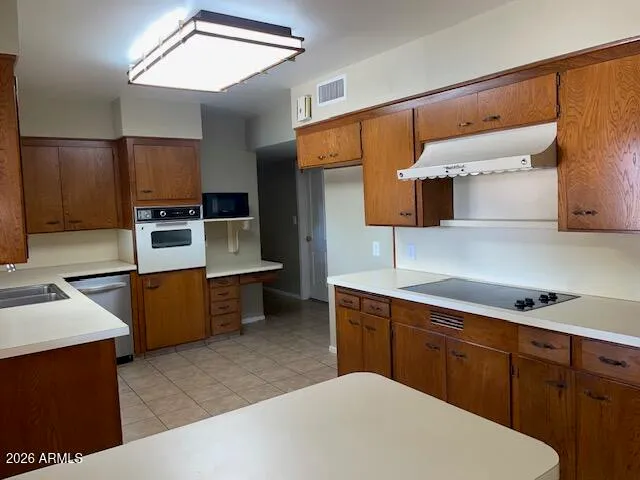 a kitchen with stainless steel appliances a sink dishwasher stove refrigerator and microwave