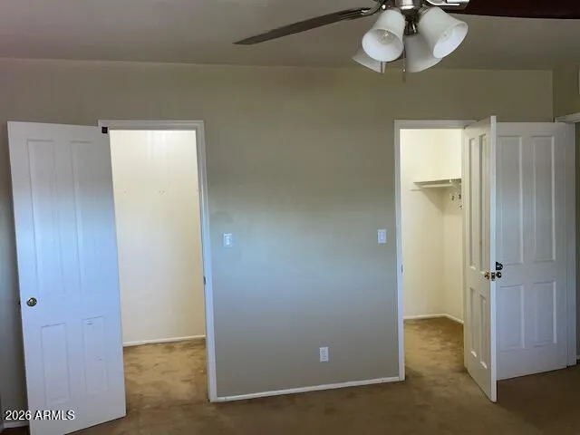 an empty room with a dining table and chandelier
