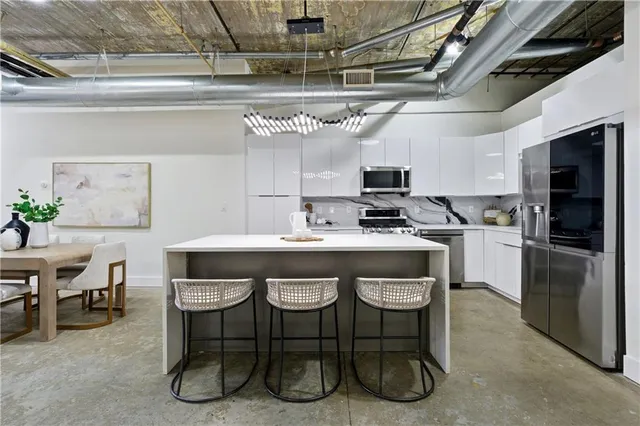 a kitchen with a sink stainless steel appliances and cabinets