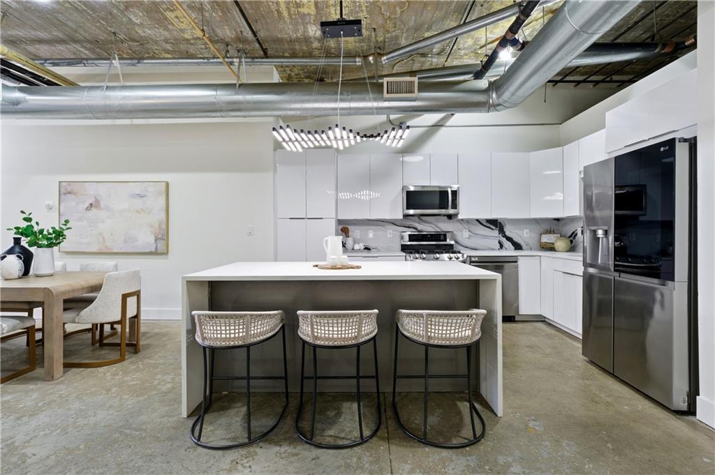 a kitchen with a sink stainless steel appliances and cabinets